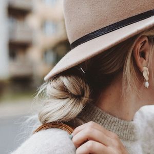 Hat and blonde braid style
